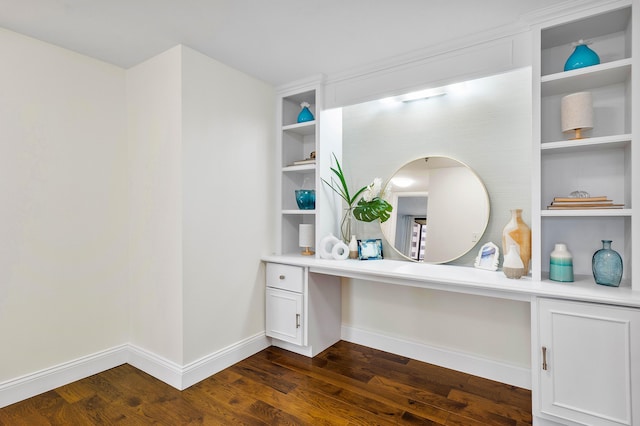 interior space with built in shelves, dark wood-style flooring, built in study area, and baseboards