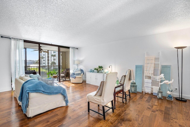 interior space with dark wood-style flooring, floor to ceiling windows, a textured ceiling, and baseboards