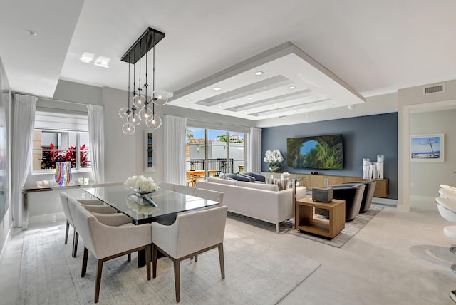 dining space featuring a raised ceiling