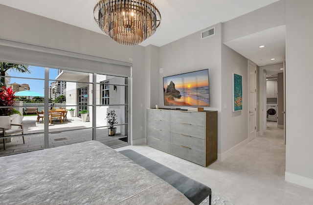 bedroom with an inviting chandelier, access to exterior, and washer / dryer