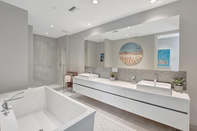 bathroom with vanity, plus walk in shower, and decorative backsplash