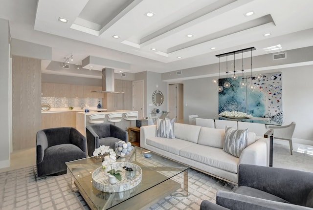 living room with a tray ceiling