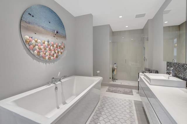 bathroom featuring vanity, separate shower and tub, and backsplash