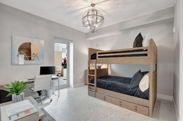 bedroom featuring an inviting chandelier and light colored carpet