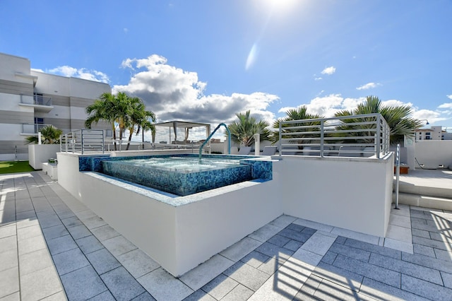 view of pool with an in ground hot tub and a patio area