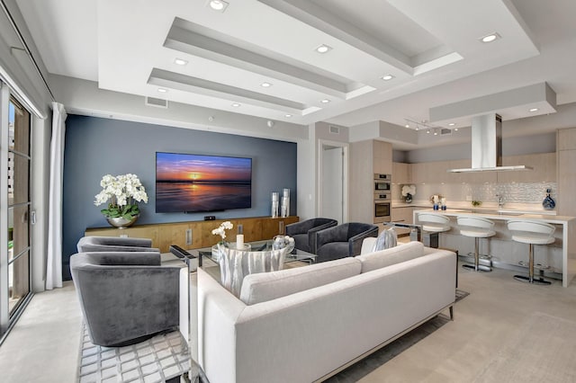 carpeted living room with a raised ceiling