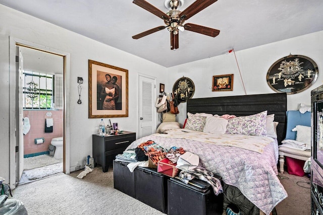 bedroom featuring ceiling fan, connected bathroom, carpet flooring, and a closet