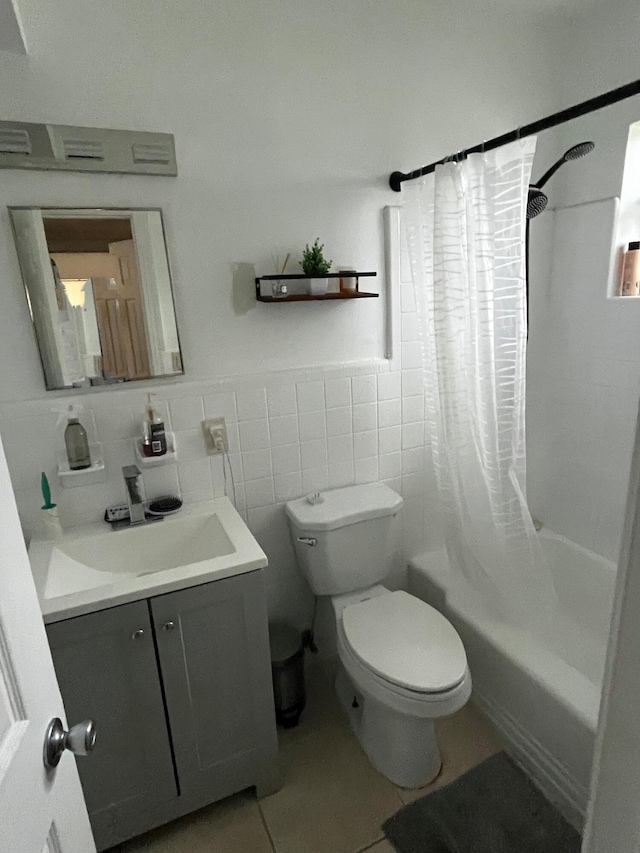 full bathroom featuring shower / bath combination with curtain, vanity, toilet, and tile walls