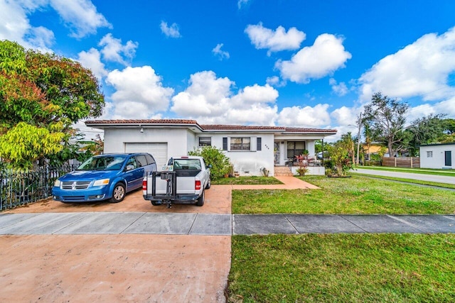 view of front of property with a garage, covered porch, and a front yard