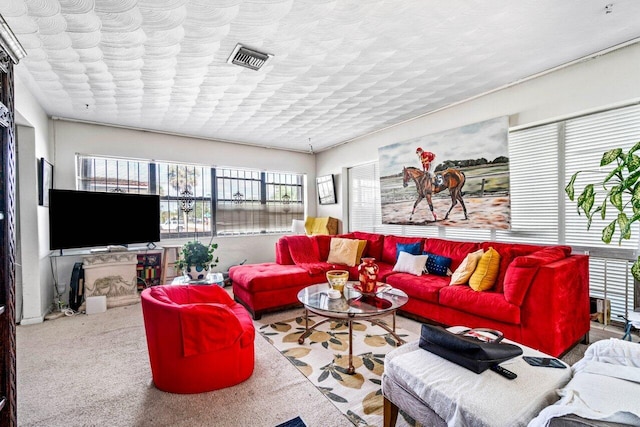 living room featuring carpet floors and a textured ceiling