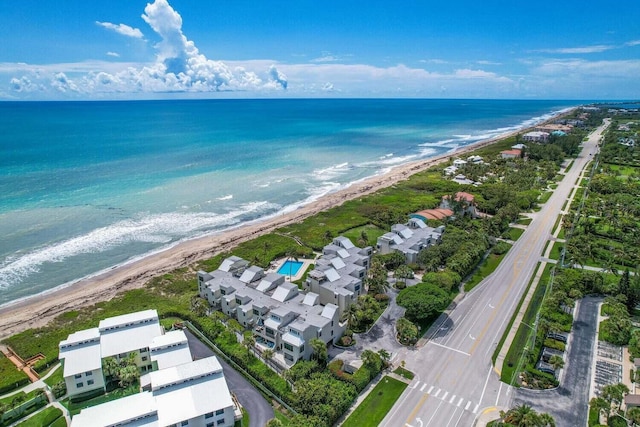 birds eye view of property featuring a view of the beach and a water view