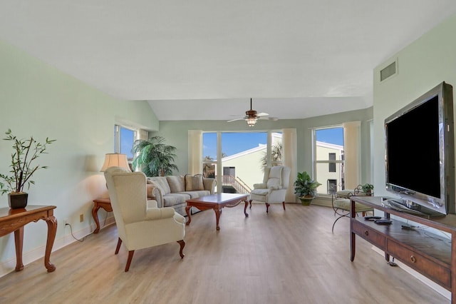 living room with vaulted ceiling, ceiling fan, and light hardwood / wood-style floors