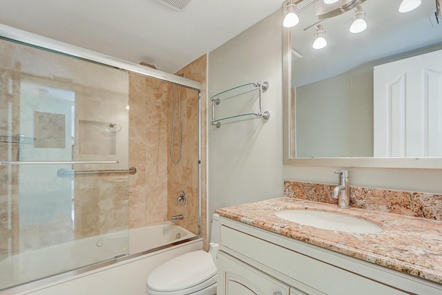 full bathroom with toilet, vanity, and shower / bath combination with glass door