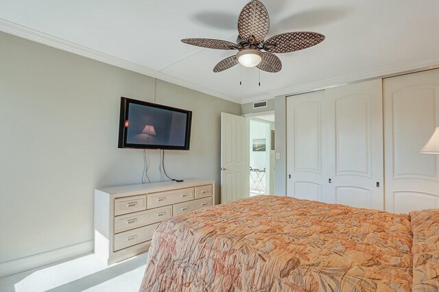 bedroom with crown molding, light carpet, and ceiling fan