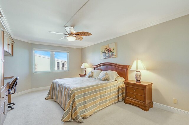 bedroom featuring crown molding, a closet, light colored carpet, ceiling fan, and baseboards