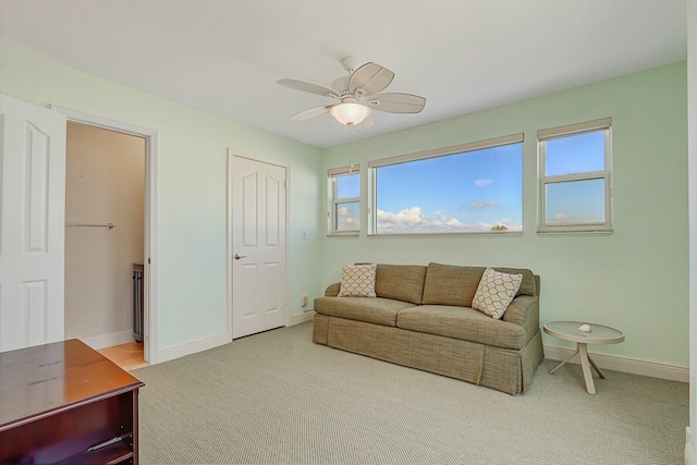 living room with light colored carpet and ceiling fan