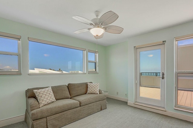 carpeted living room featuring ceiling fan