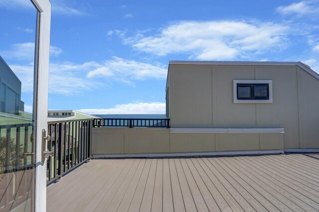 wooden deck featuring a water view