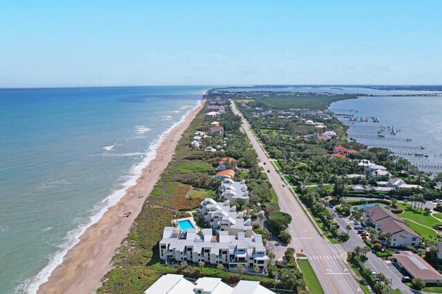 aerial view with a water view and a beach view