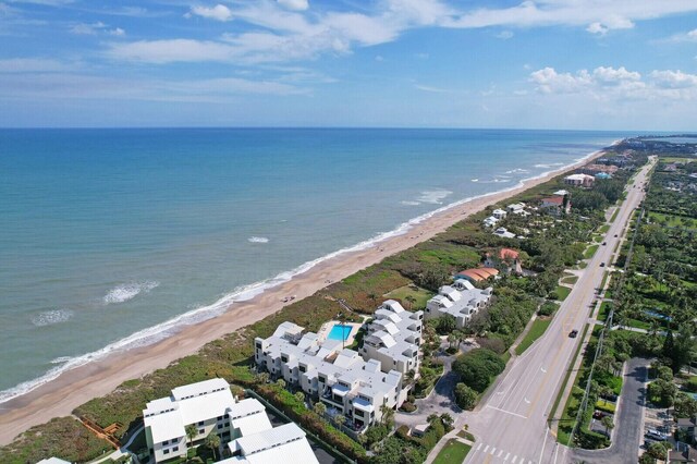 birds eye view of property featuring a water view and a view of the beach