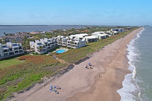 aerial view with a water view and a view of the beach