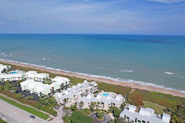 birds eye view of property with a beach view, a water view, and a residential view