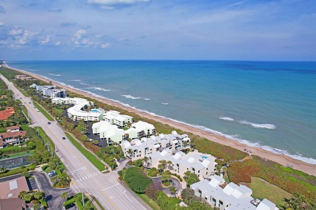 birds eye view of property featuring a water view, a residential view, and a beach view