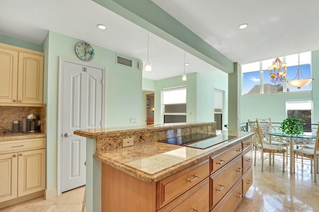 kitchen with backsplash, a center island, black electric cooktop, decorative light fixtures, and a chandelier