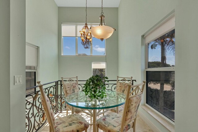 kitchen featuring a chandelier, black electric cooktop, backsplash, a center island, and pendant lighting