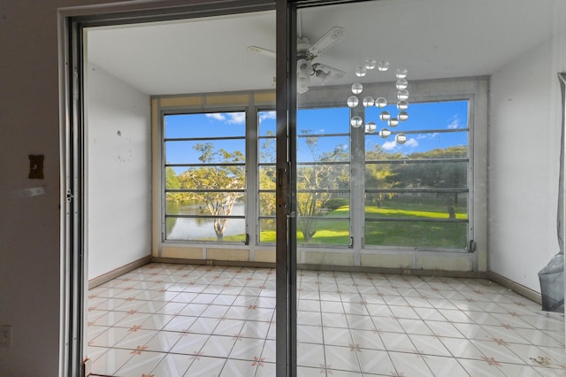 unfurnished sunroom featuring a water view