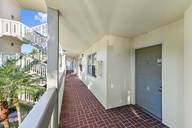 view of exterior entry with a balcony