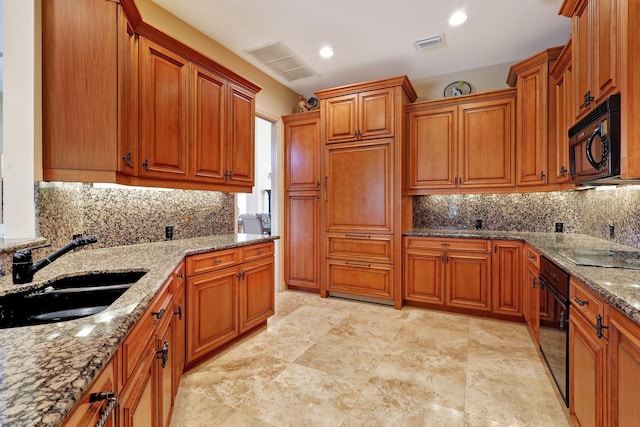 kitchen with sink, backsplash, black appliances, and light stone countertops