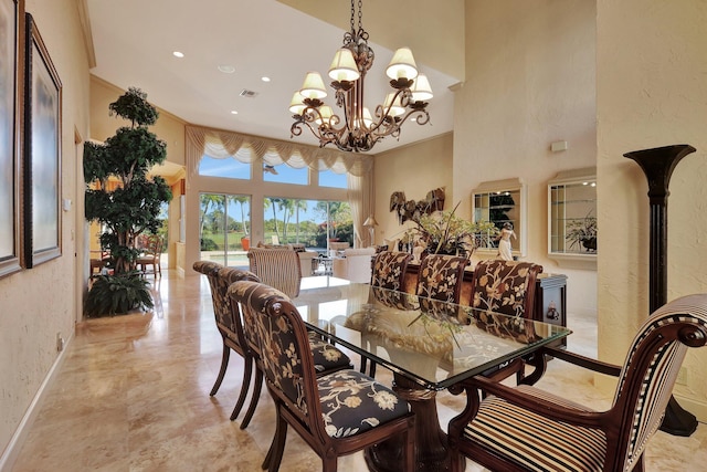 dining area featuring a chandelier and a high ceiling