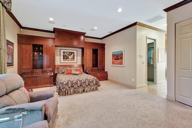 carpeted bedroom featuring crown molding, a spacious closet, and a closet