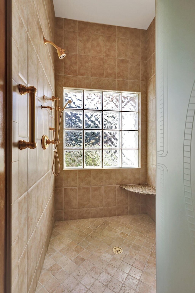 bathroom with a tile shower