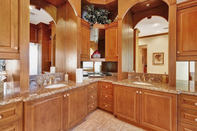 kitchen featuring sink, light stone countertops, and light tile patterned flooring