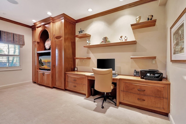 office area featuring crown molding, built in desk, and light colored carpet