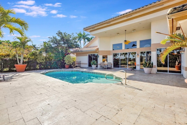 view of swimming pool with ceiling fan and a patio area