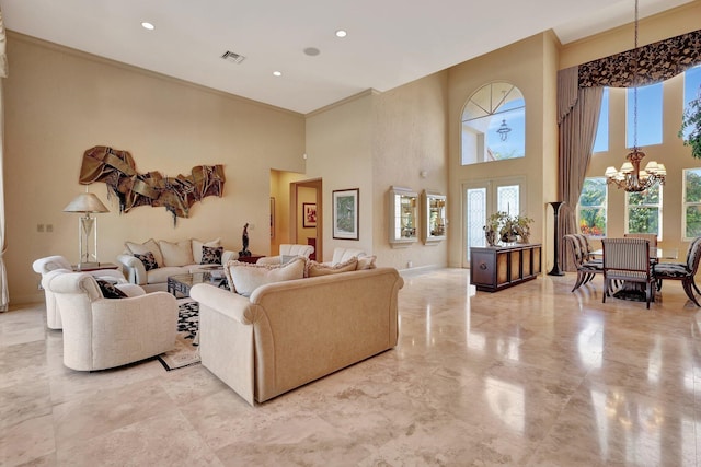 living room featuring a towering ceiling, a notable chandelier, and french doors