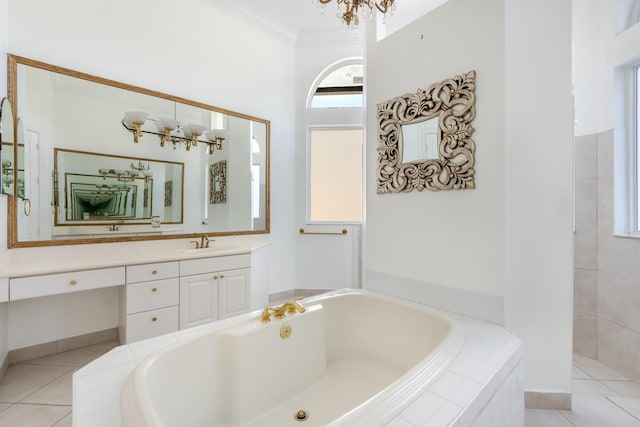 bathroom with tile patterned flooring, ornamental molding, vanity, a notable chandelier, and tiled tub