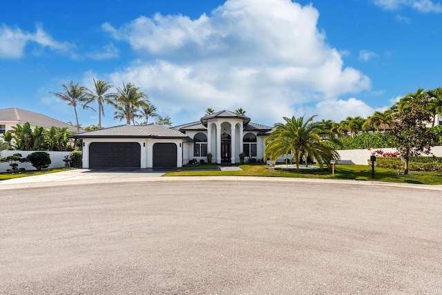 mediterranean / spanish home with a garage