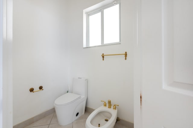 bathroom featuring a bidet, tile patterned flooring, and toilet