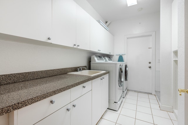 laundry area featuring cabinets, independent washer and dryer, light tile patterned flooring, and sink