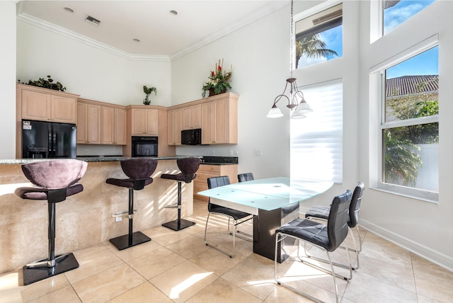 dining room with crown molding, light tile patterned flooring, and a high ceiling