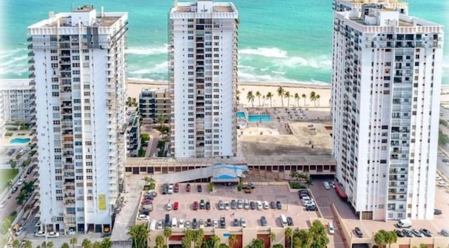 aerial view featuring a water view and a beach view