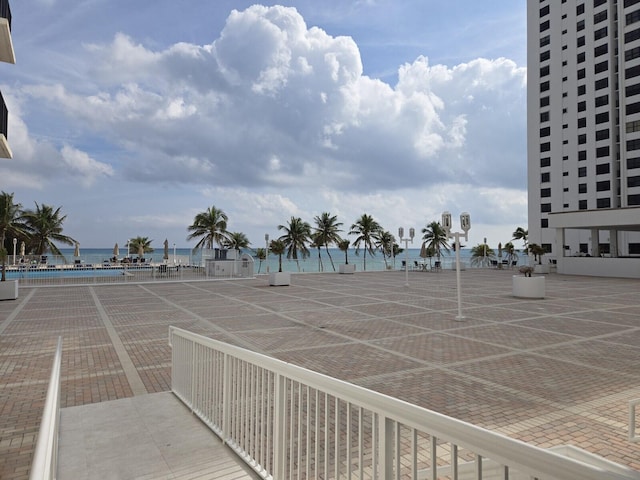 exterior space featuring a water view and tennis court