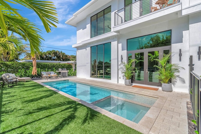 view of swimming pool featuring french doors, a lawn, a grill, an outdoor hangout area, and a patio