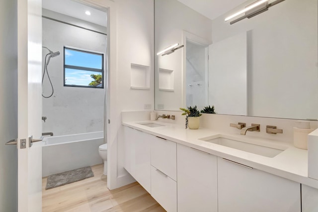 full bathroom featuring shower / tub combination, vanity, hardwood / wood-style floors, and toilet