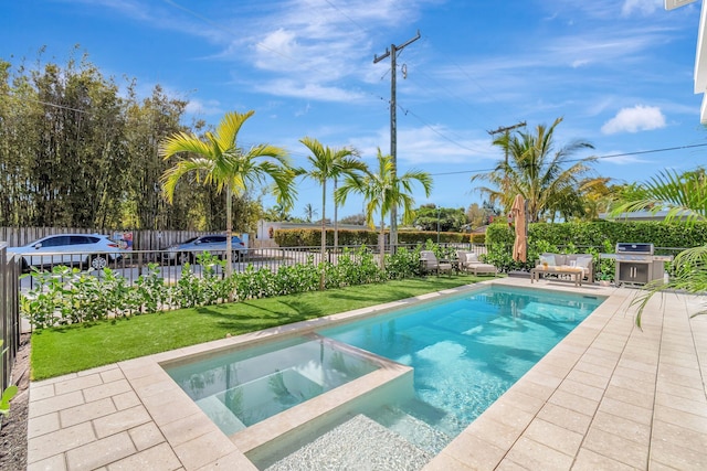 view of swimming pool featuring an in ground hot tub, a patio area, and a lawn