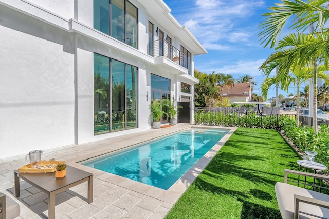 view of pool with a yard and a patio area